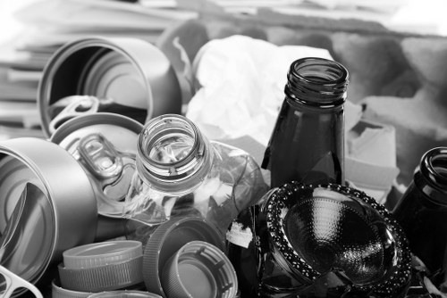 Operatives conducting a site risk assessment near a skip